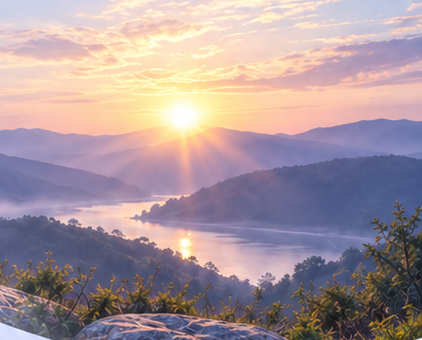 Sunrise over a river winding through mountain ranges